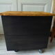 Vintage furniture with metal plugs on black wheels wooden tray