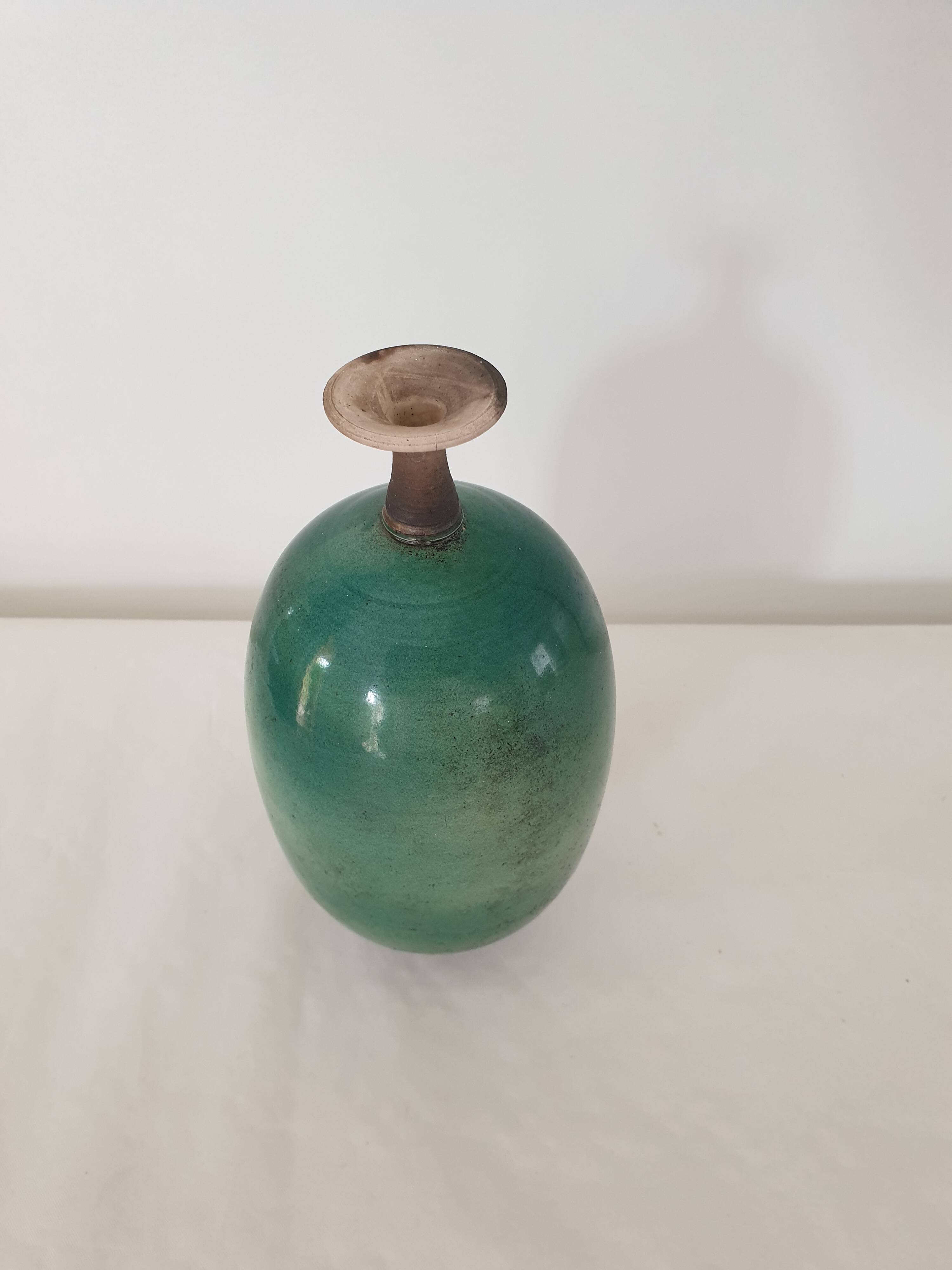 Green pot-bellied ceramic vase with foot and high, narrow neck in signed raku