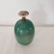 Green pot-bellied ceramic vase with foot and high, narrow neck in signed raku