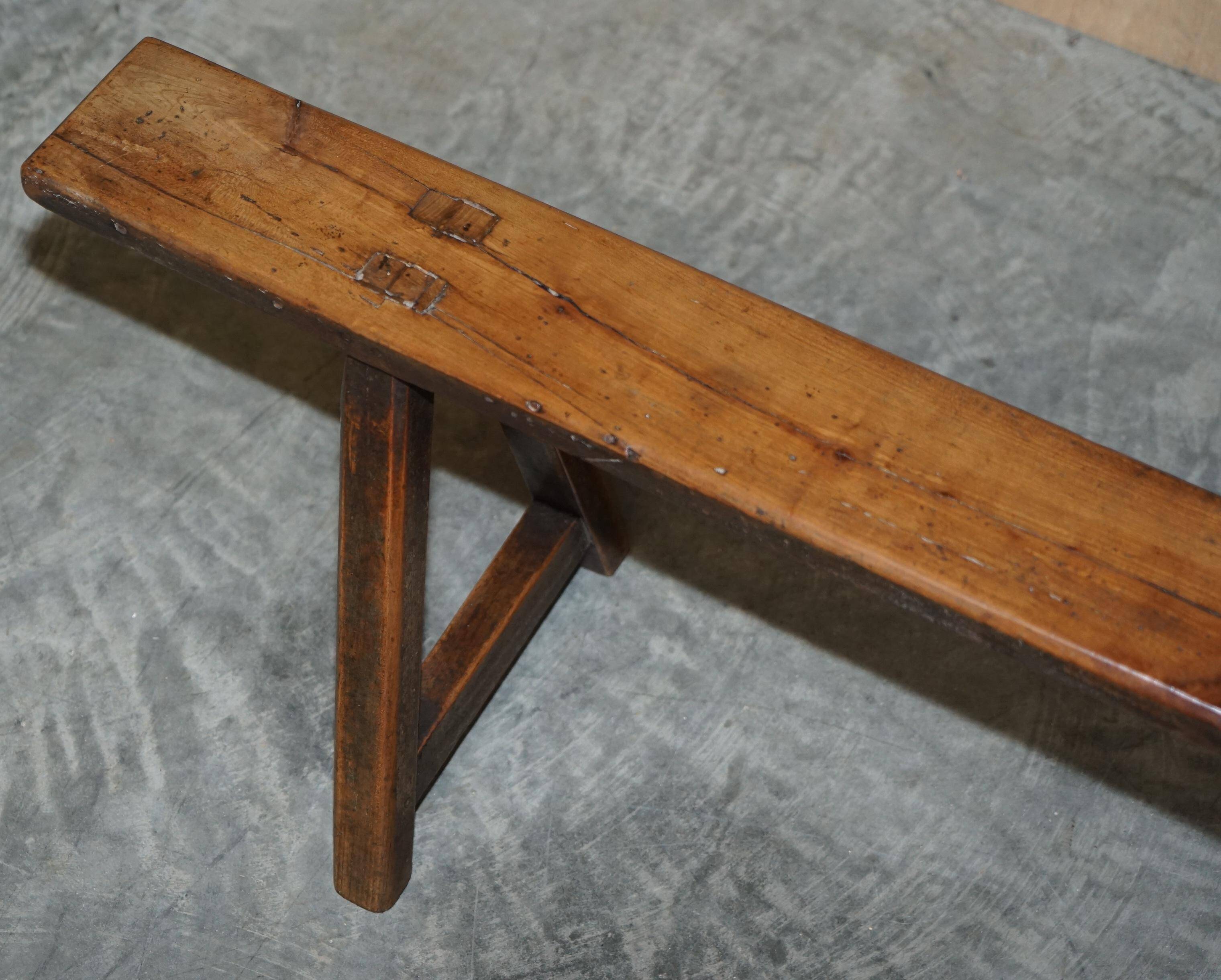 Pair of antique Victorian trestle benches in fruitwood.