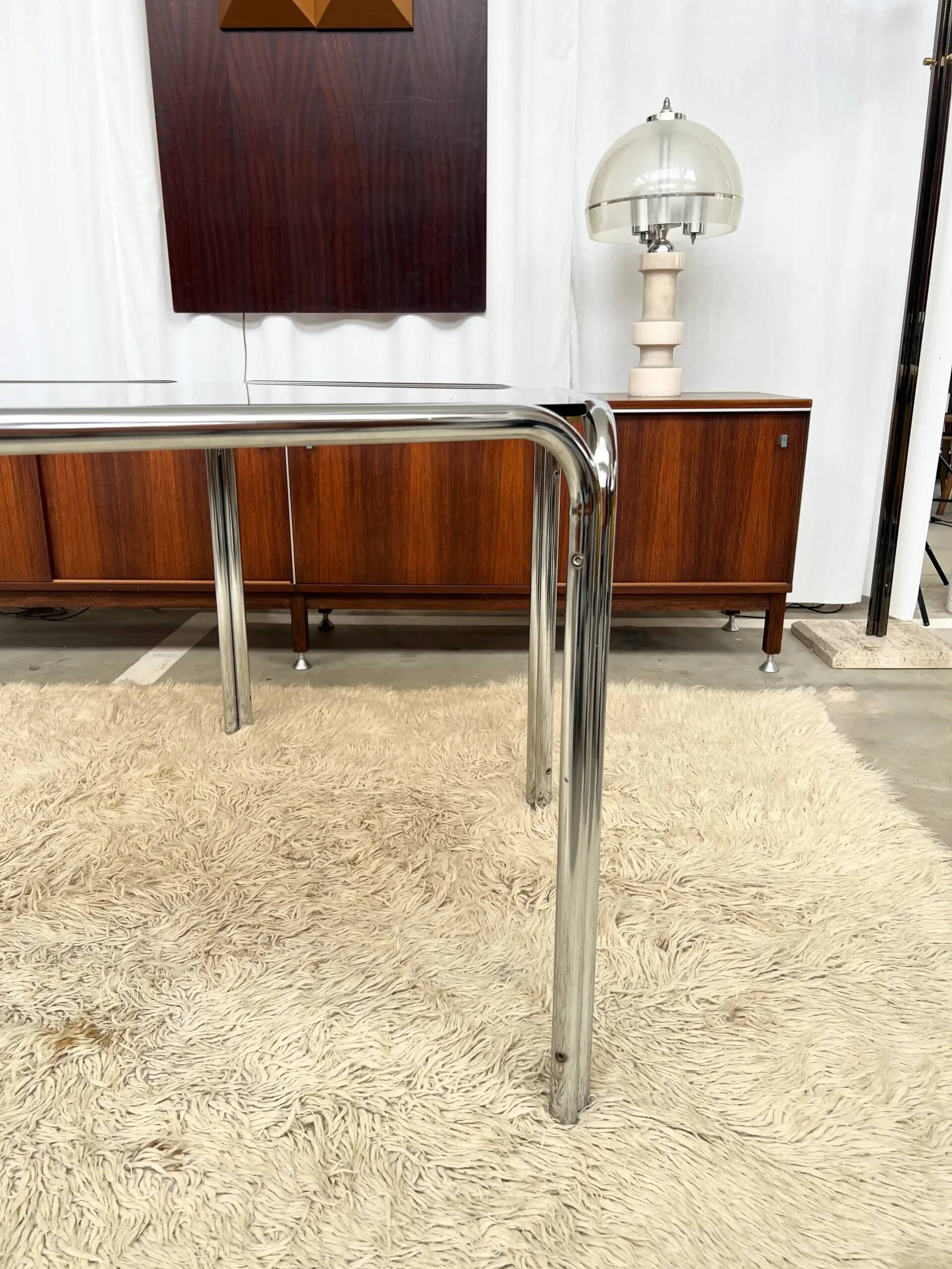 Vintage hexagonal table with smoked glass top and chrome metal structure.