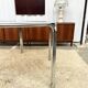 Vintage hexagonal table with smoked glass top and chrome metal structure.