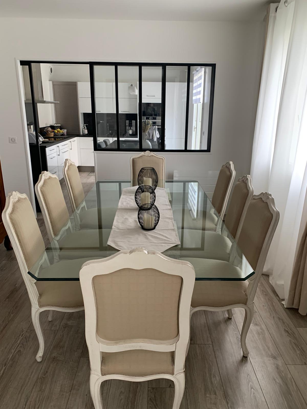 Table with a glass top and 8 chairs.