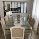 Table with a glass top and 8 chairs.