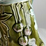 Green slip milk jug with floral patterns.