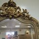 Large carved and gilded wooden mirror, rectangular in shape.