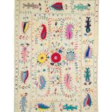 White suzani kilim rug with hand embroidered multi-colored patterns