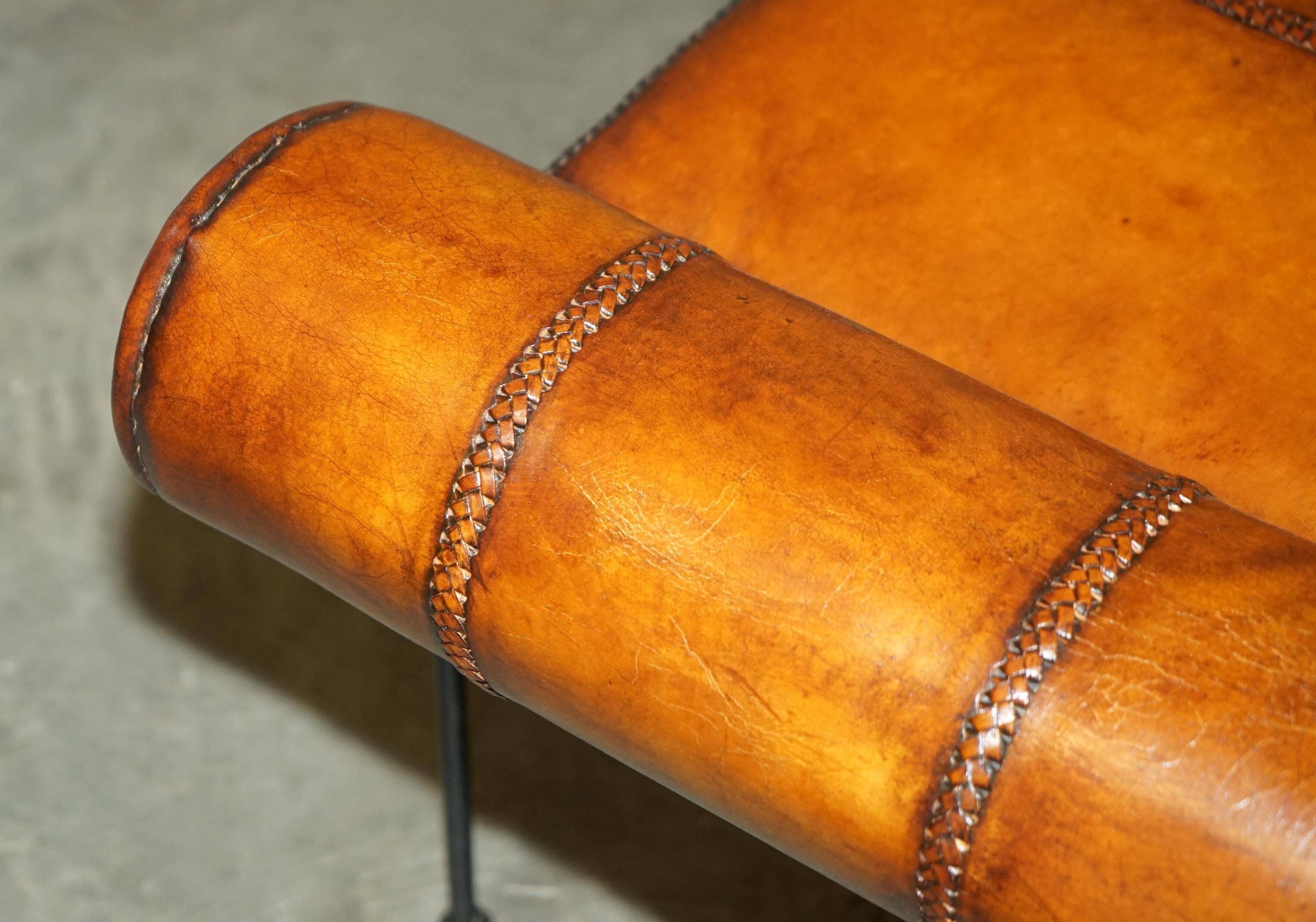 Vintage Spanish window bench in hand-stitched leather and restored iron.