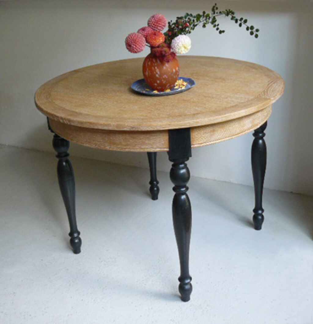 Round table in coloured cerused oak, waxed coloured feet