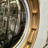 Witch mirror porthole style in gilded wood, diameter 44 cm.