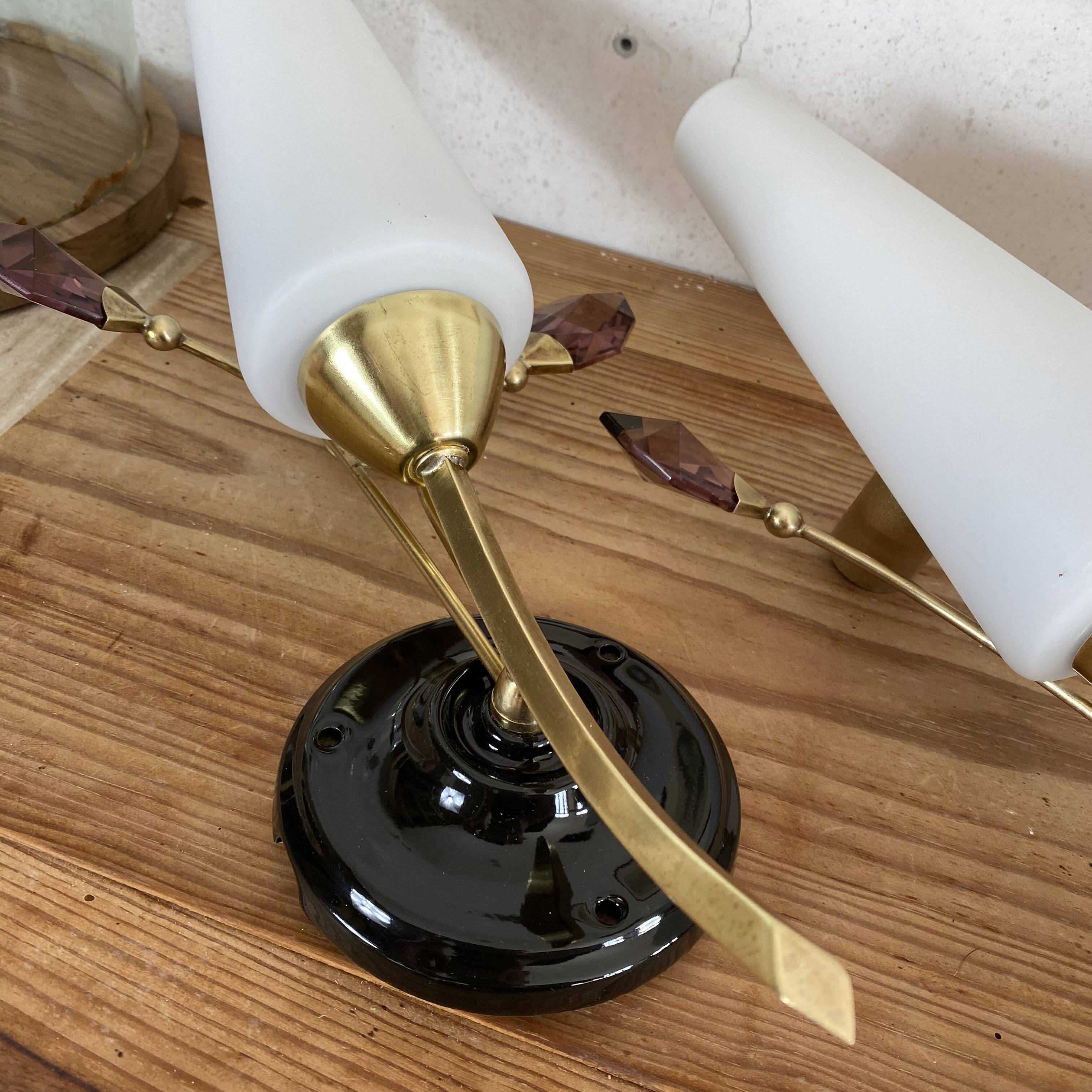Pair of wall sconces in brass with white glass tulips.