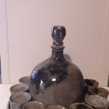Ceramic liquor service with a decanter and 12 small glasses on tray
