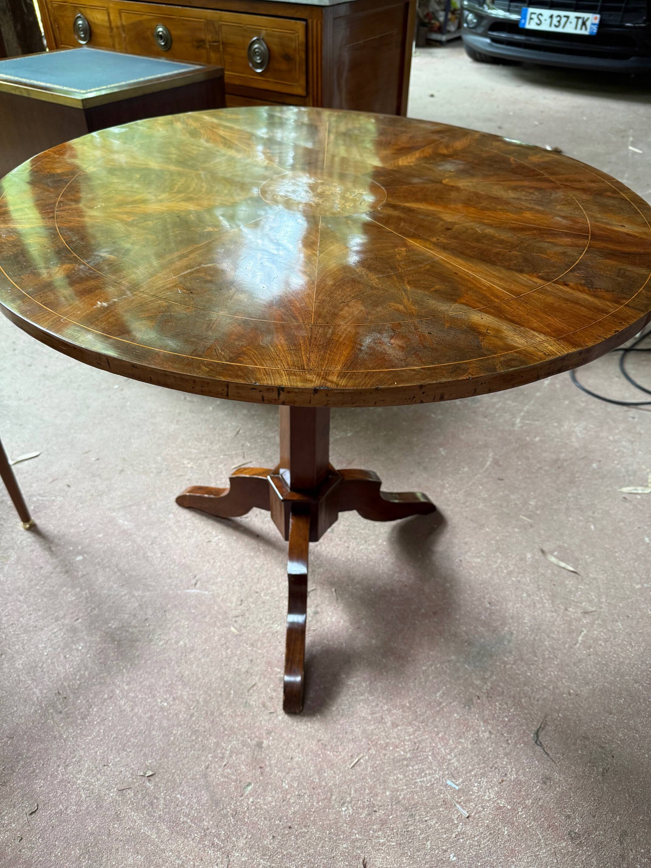 Antique round table with floral details.