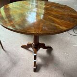 Antique round table with floral details.