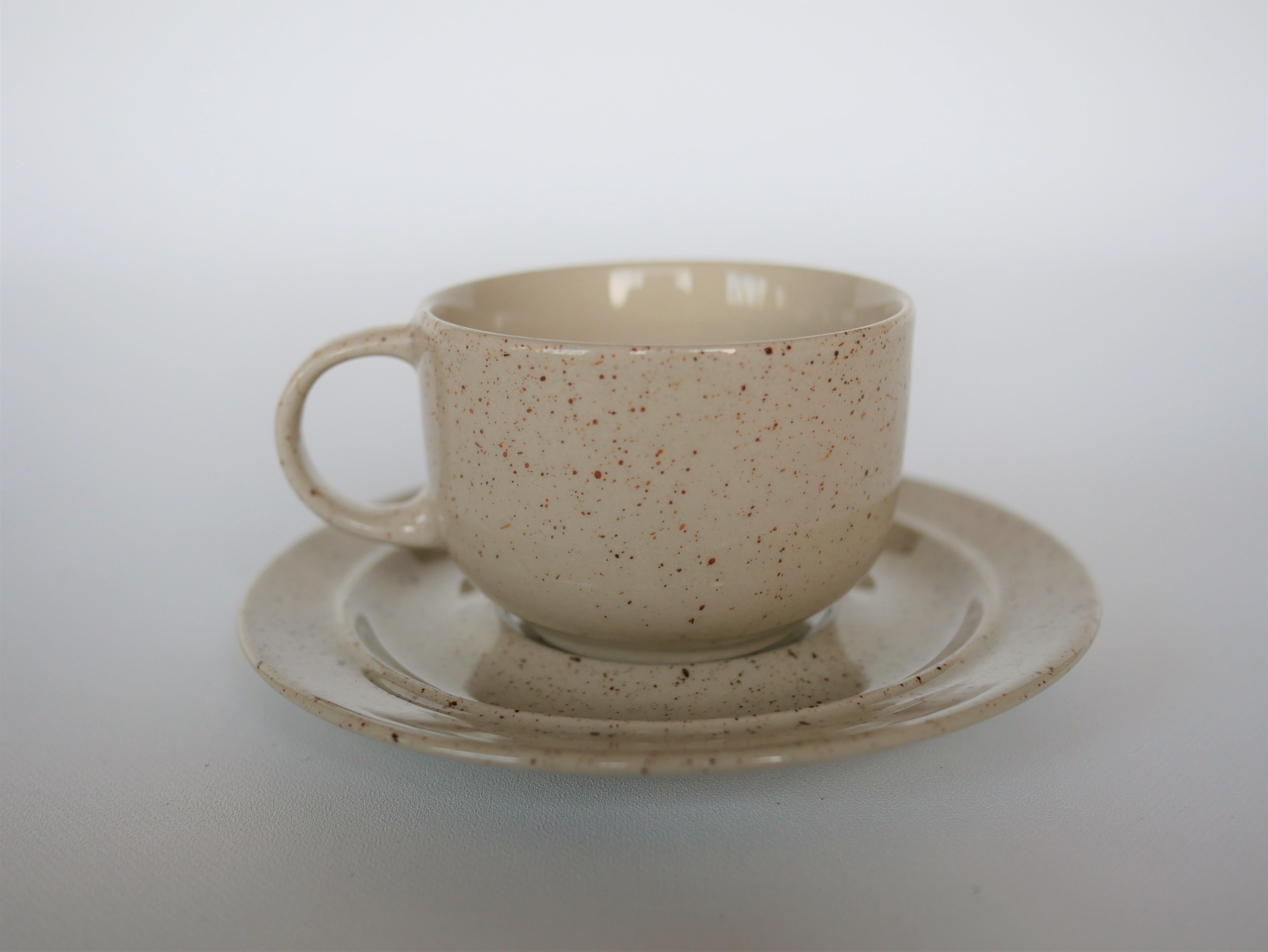 Coffee cup and vintage pyrity sandstone subcup