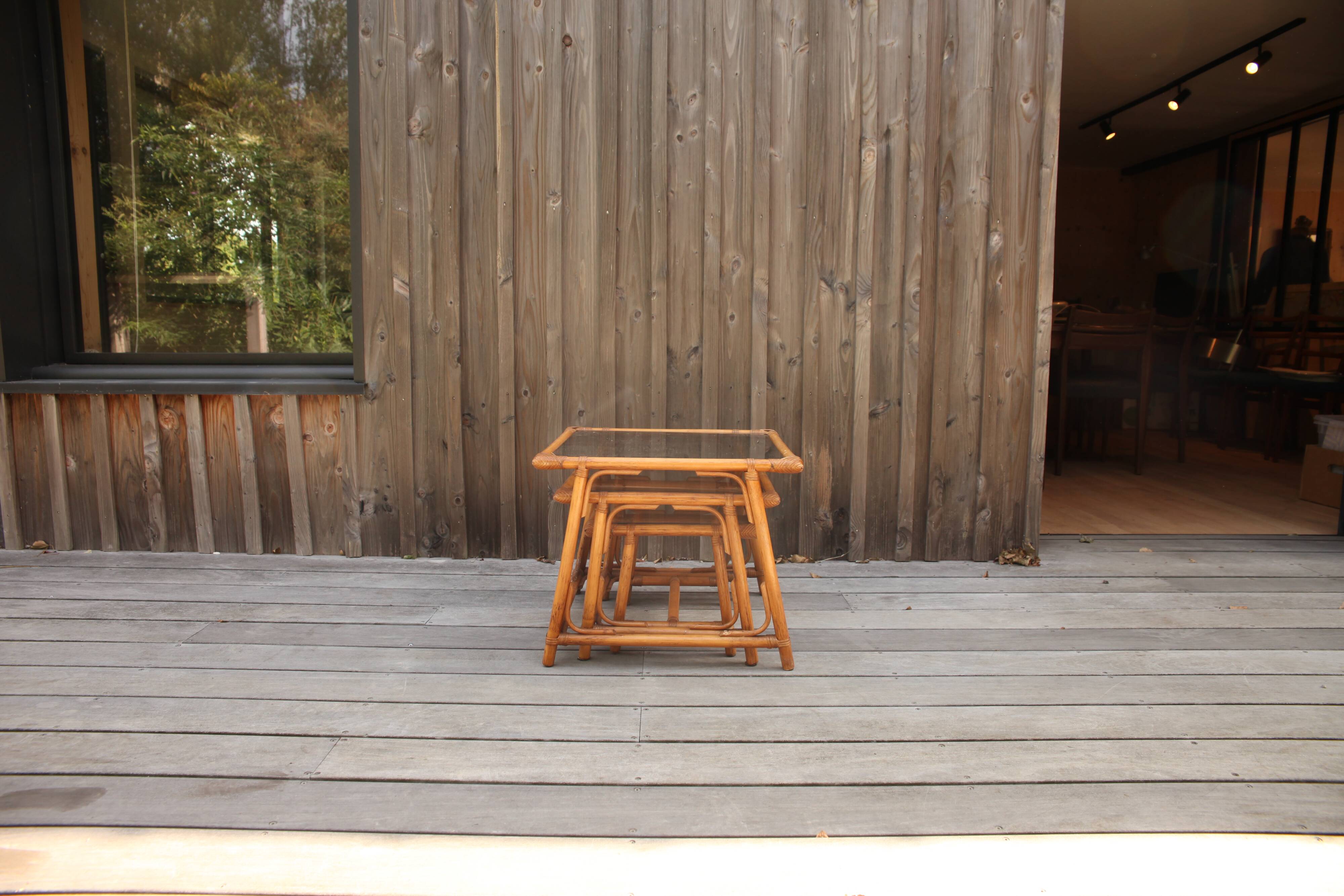 Nesting tables in rattan and glass