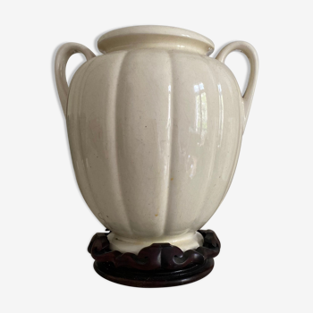 Ceramic vase with handle on its wooden base