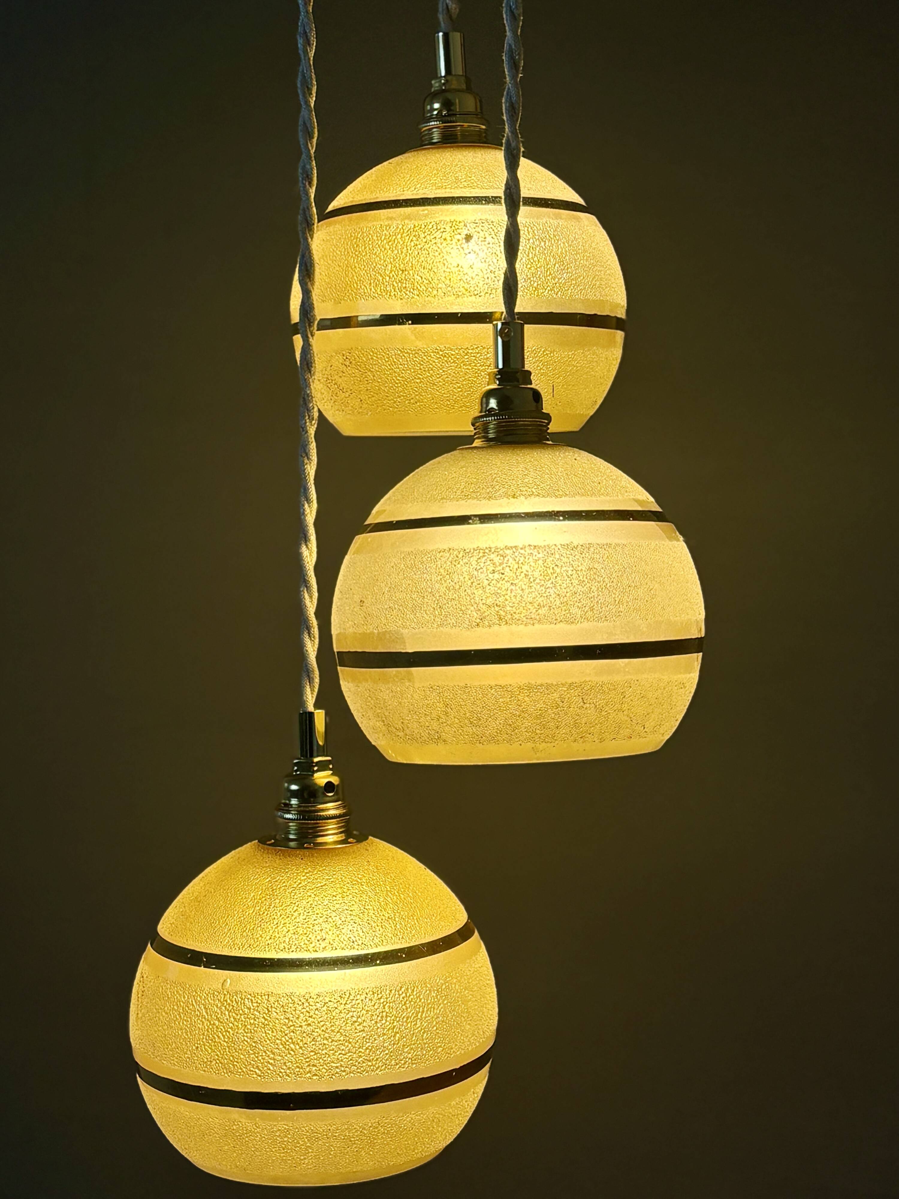 Suspension triple vintage glass globes in frosted yellow and gold.