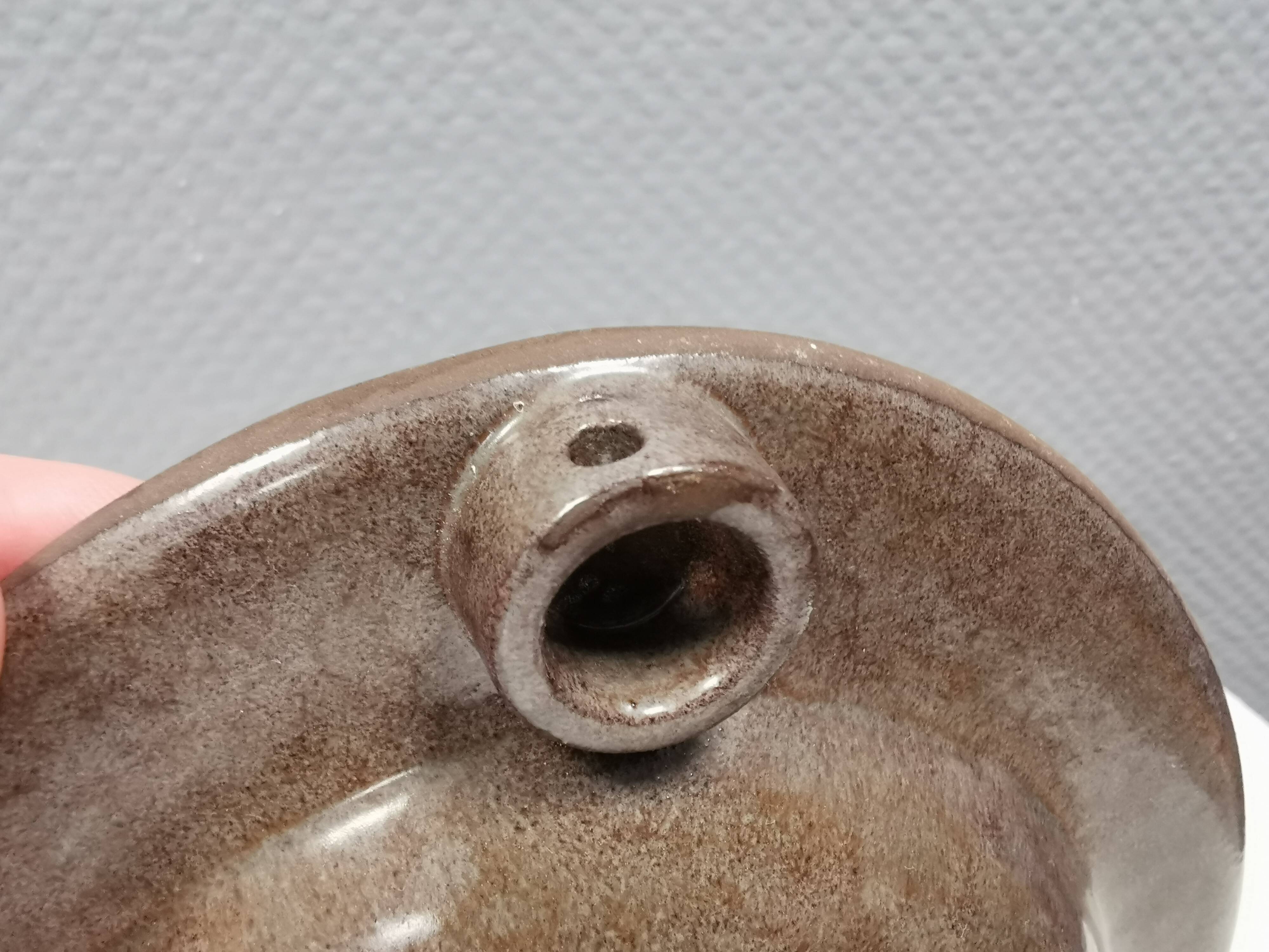 Wall-mounted candlestick in grayish colors, Danish and from the 1970s-80s.