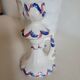 Ceramic candlestick with red and blue decoration.