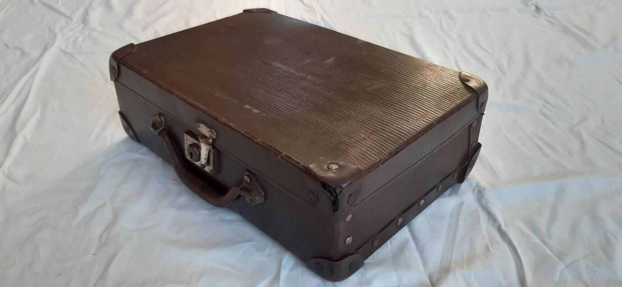 Small old suitcase with a ribbed appearance