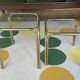 Pair of small nesting coffee tables in gold tubular metal & transparent glass tops