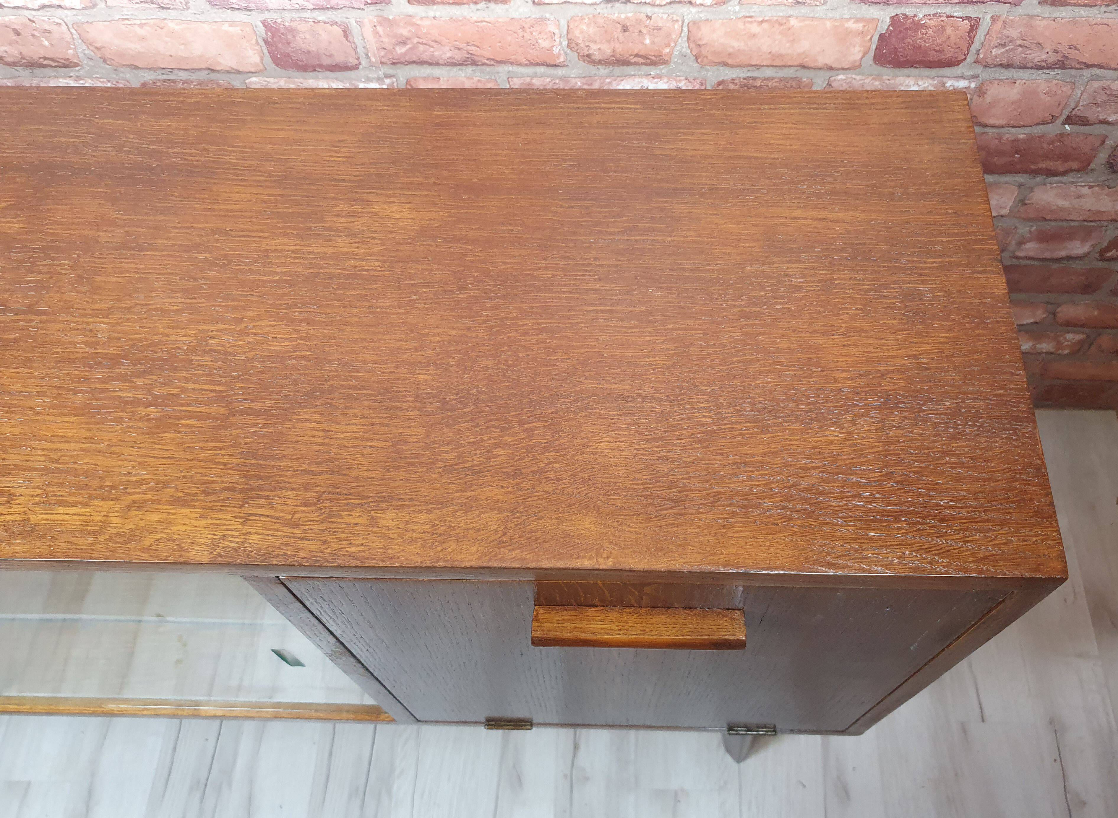 Renovated oak display cabinet with a bar on slanted legs