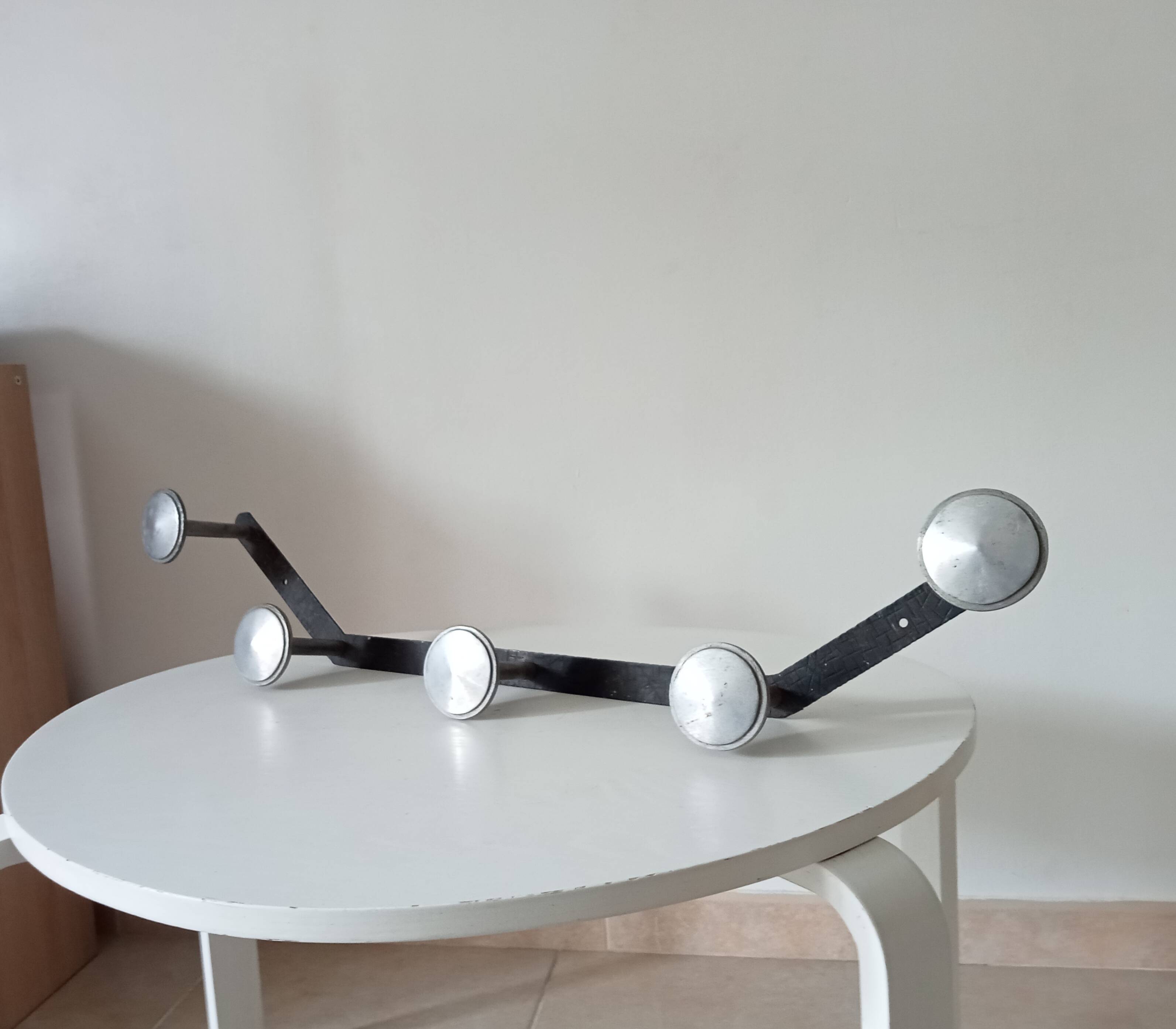 Vintage 1950s wall coat rack, wrought iron with chiselled details and solid aluminium.