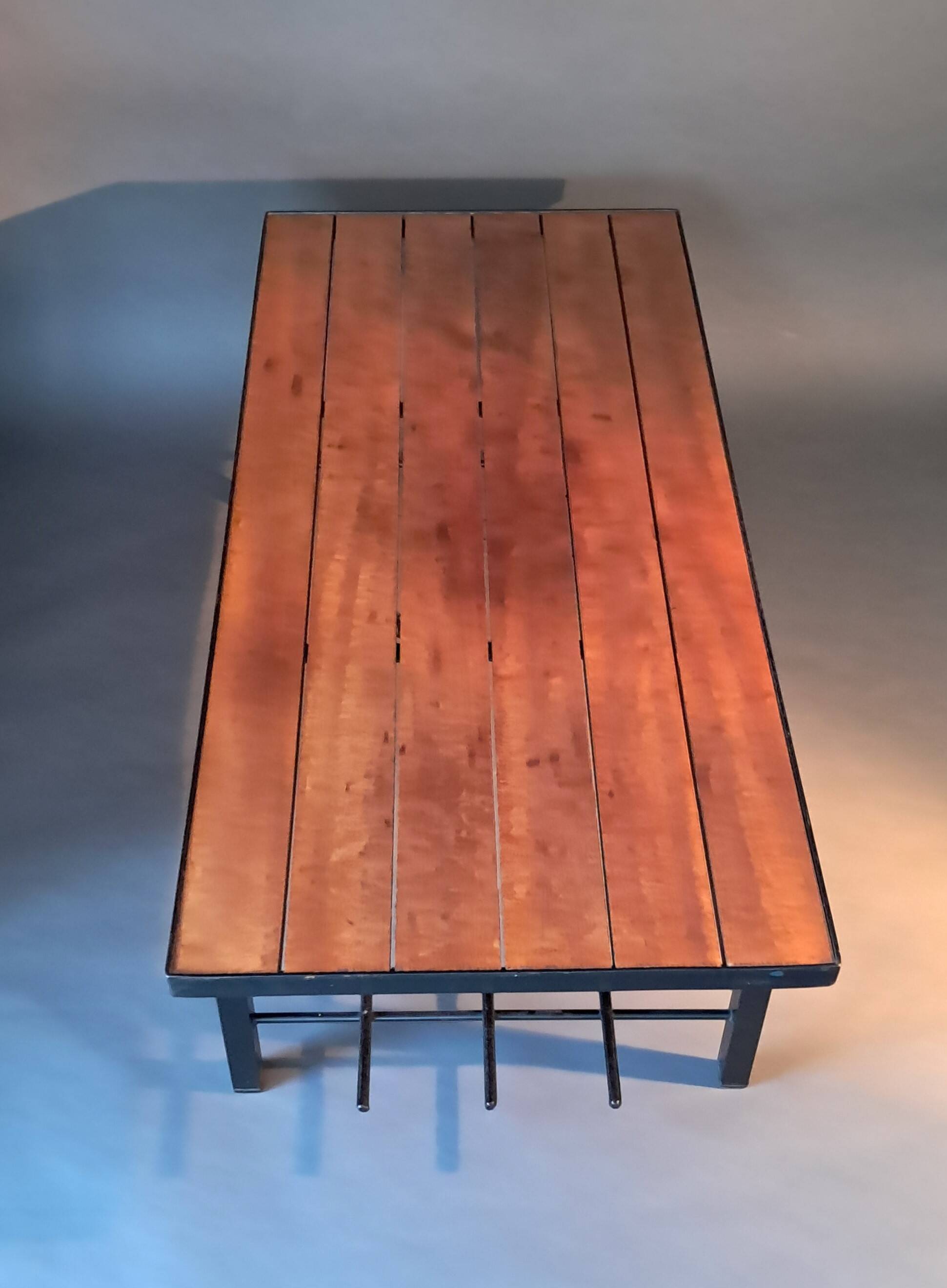 Vintage modernist coffee table in teak and black metal.