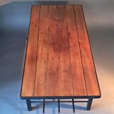 Vintage modernist coffee table in teak and black metal.