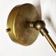 Articulated brass and lacquered iron wall light, 1950s design.