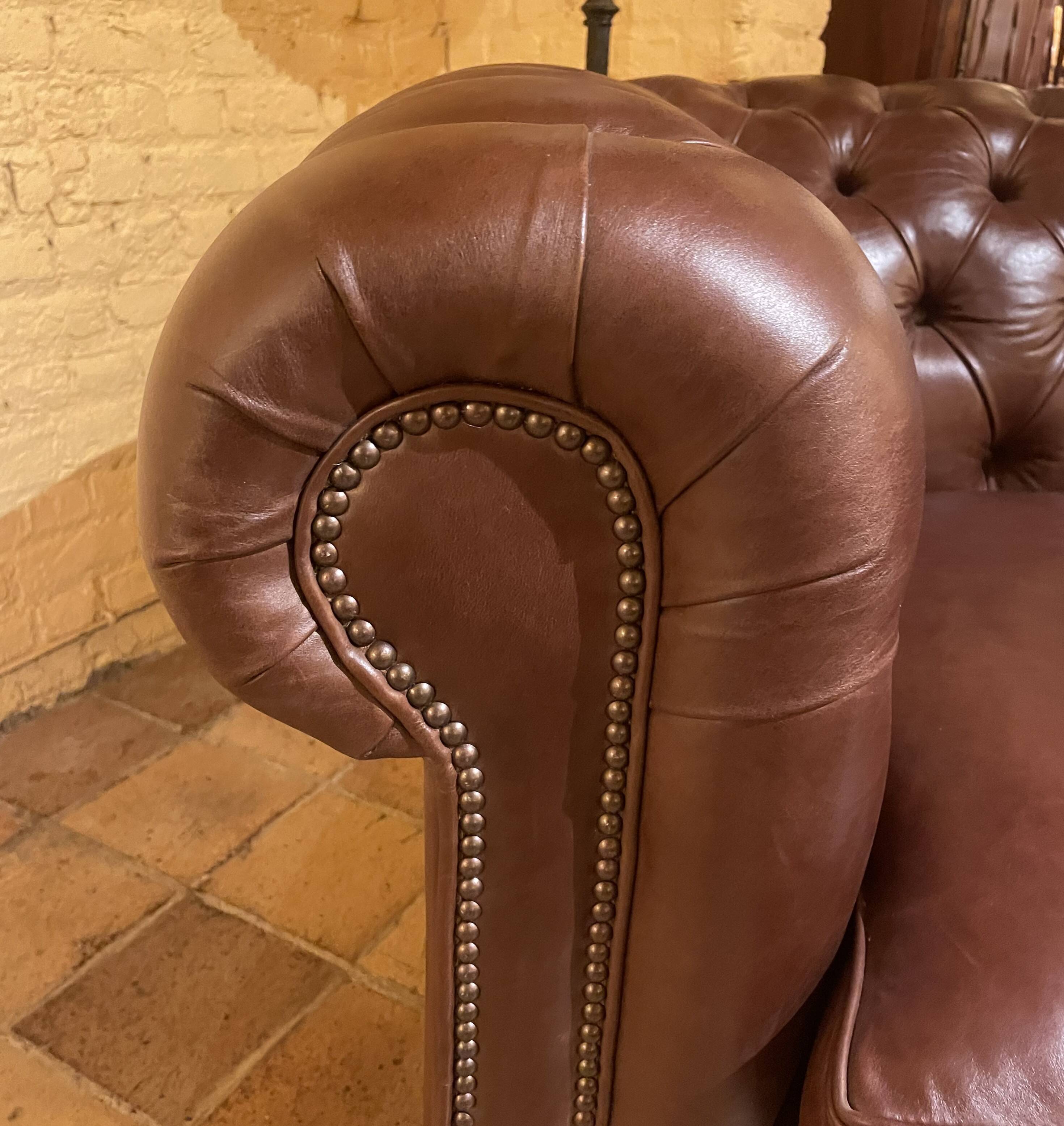 brown leather 2-seater Chesterfield sofa