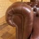 brown leather 2-seater Chesterfield sofa