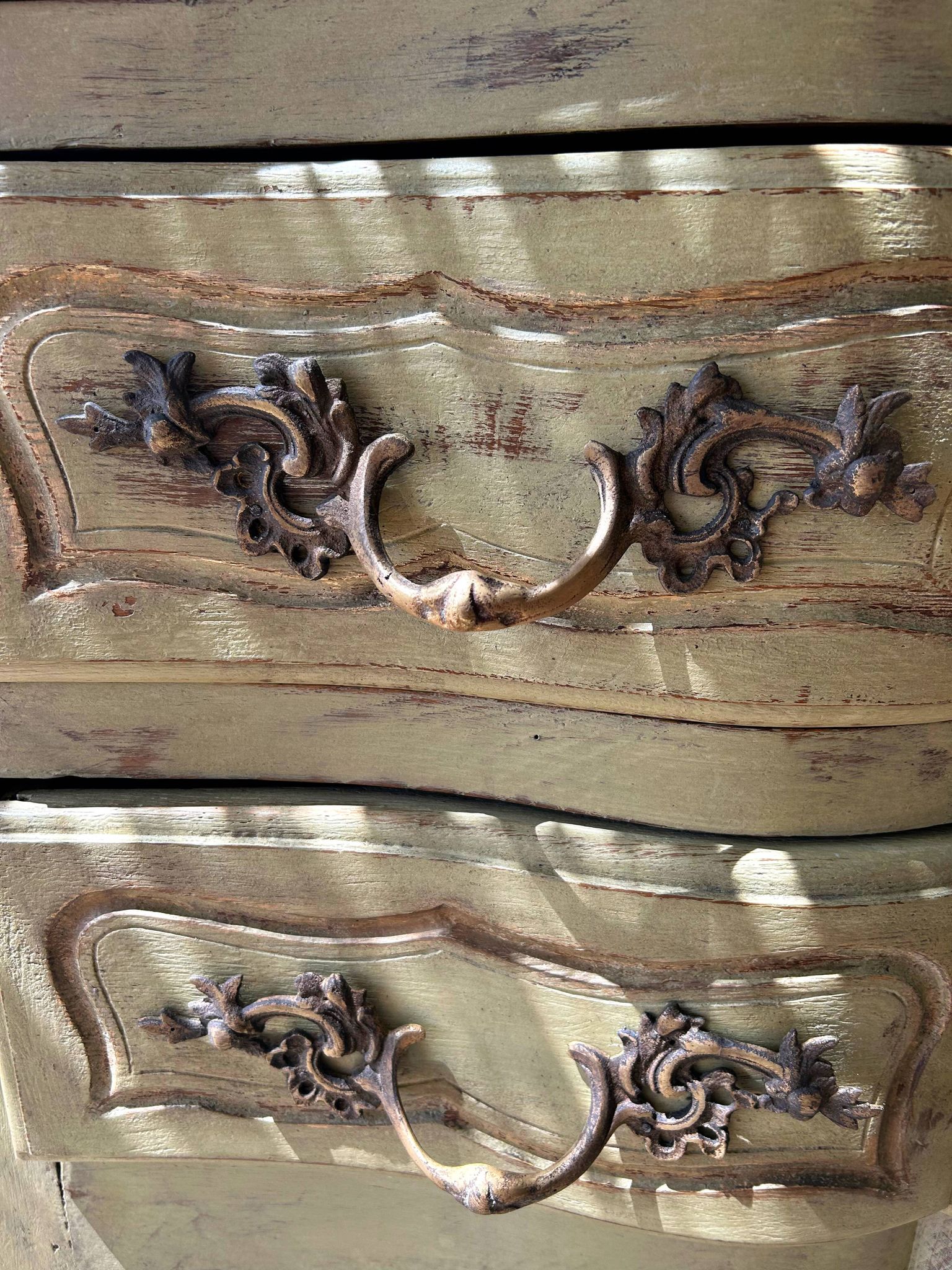 Curved antique commode in pistachio green patina.