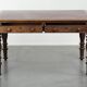 Antique English writing desk from the 19th century with a red leather top