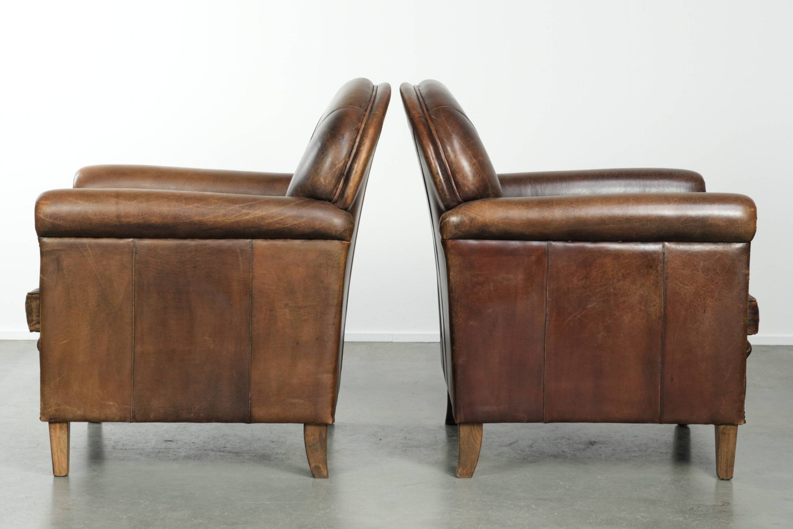 Characterful set of two sheepskin design armchairs with beautiful patina