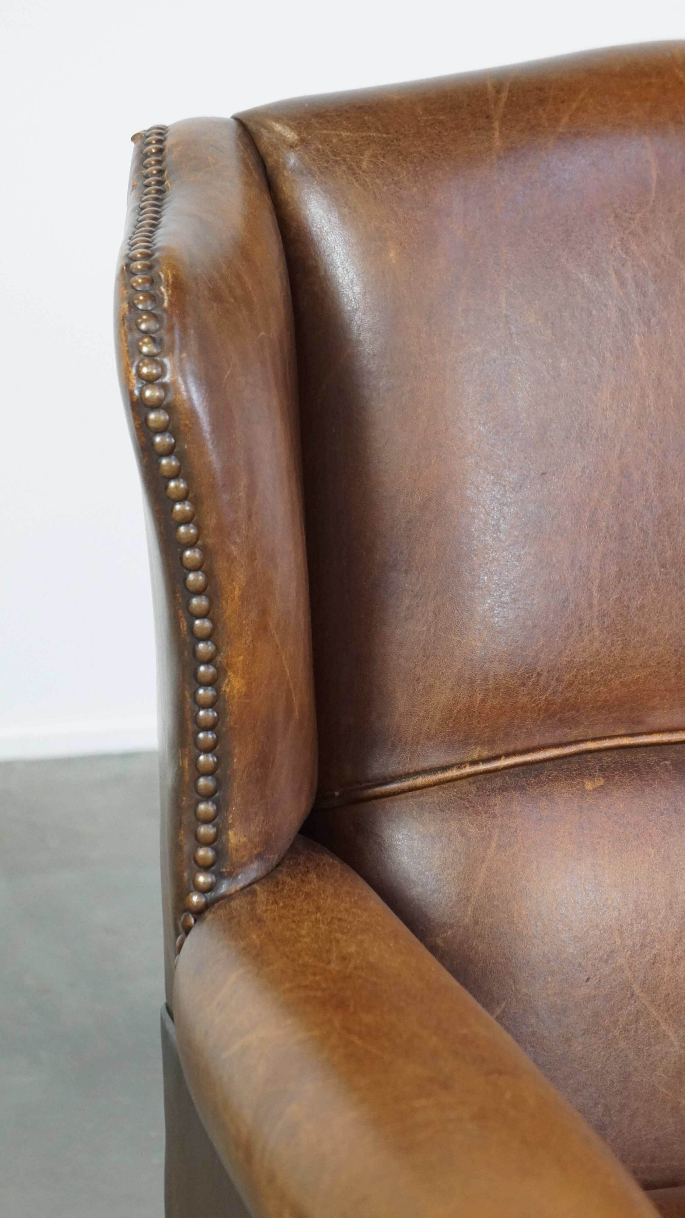 Cognac-colored sheepskin wing chair in English style