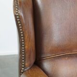 Cognac-colored sheepskin wing chair in English style