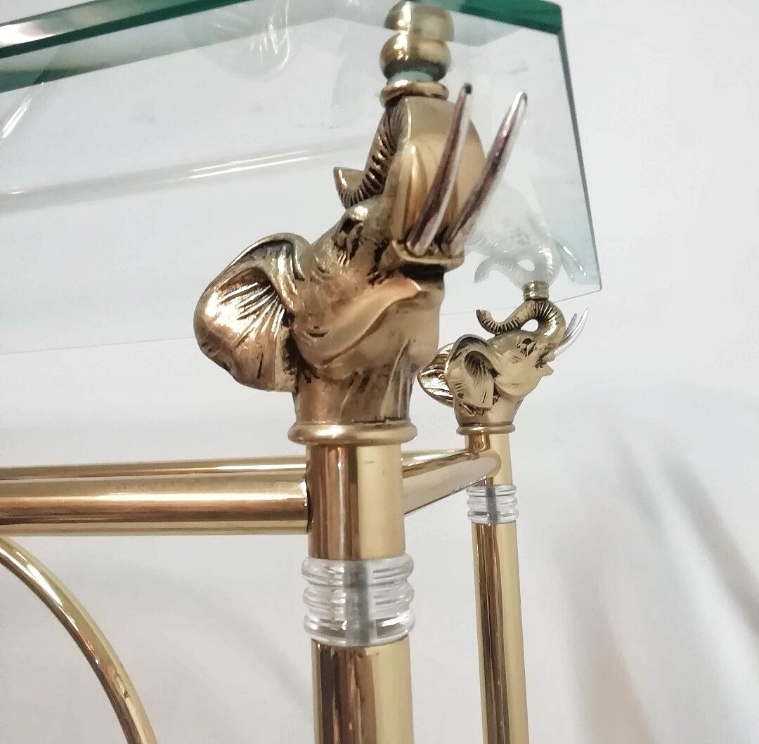 Hollywood Regency brass and glass shelf with elephant heads from the 1970s