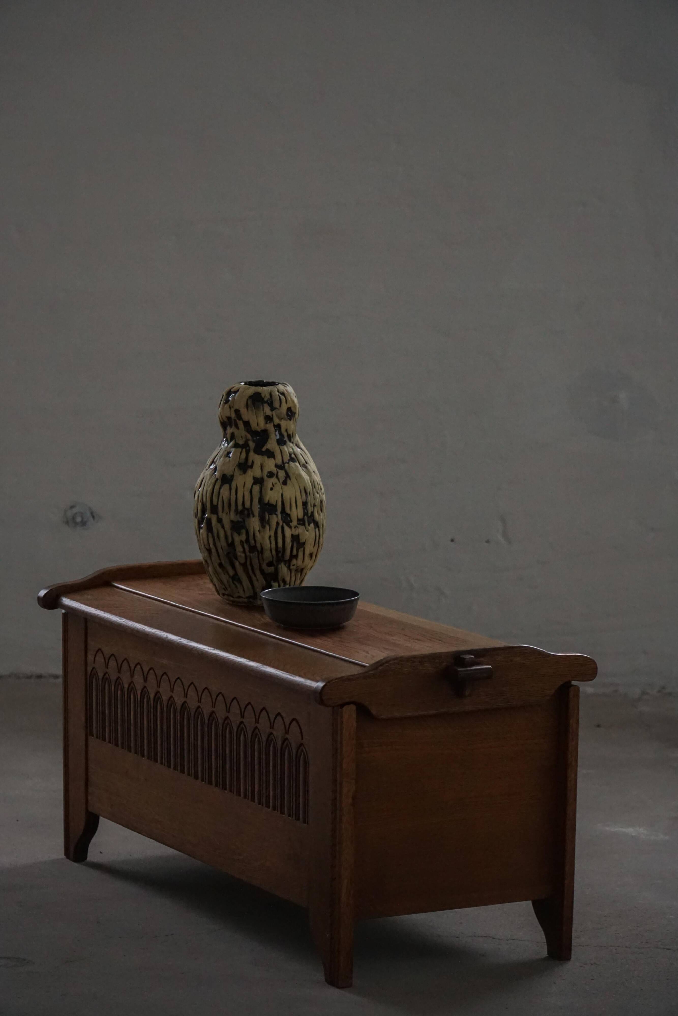 Modern Danish oak commode with decorative relief sculpture, mid-20th century.