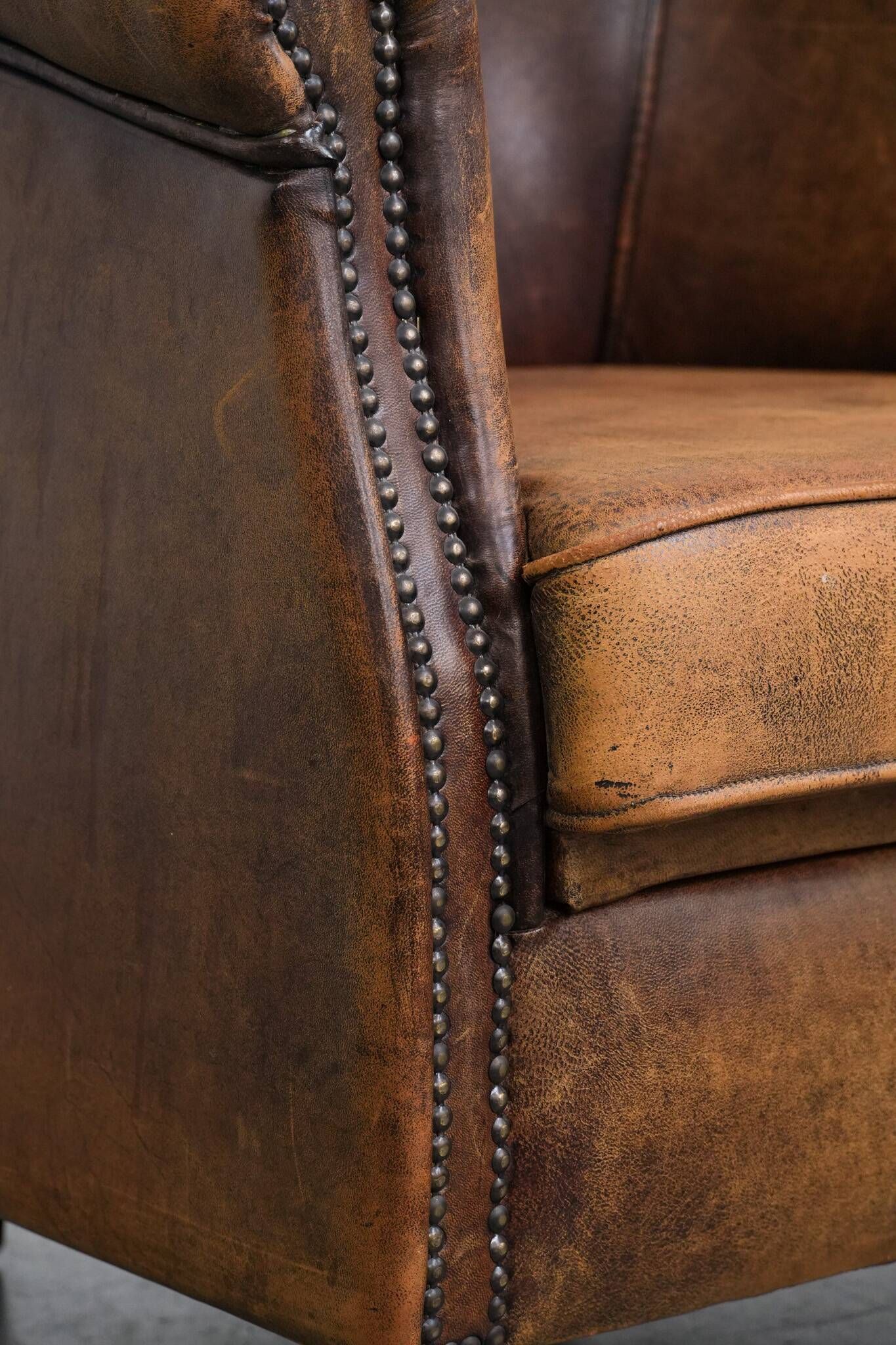 Vintage club chair in sheepskin leather with a characterful look