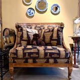 Armchair in a wooden confessional style with black and beige cotton.