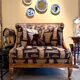 Armchair in a wooden confessional style with black and beige cotton.