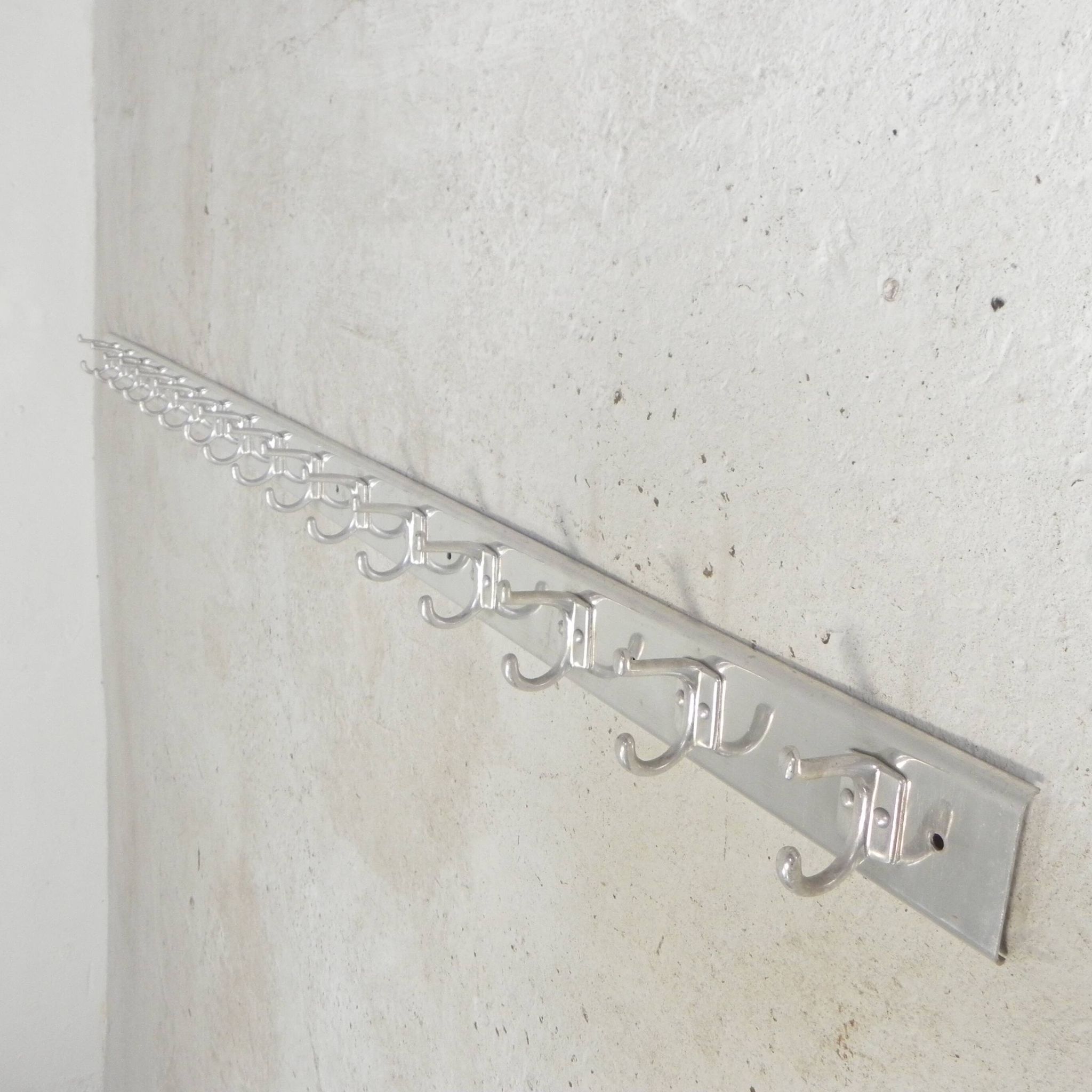 Wall-mounted aluminium coat rack of 225 cm with 16 double hooks, 1960s.