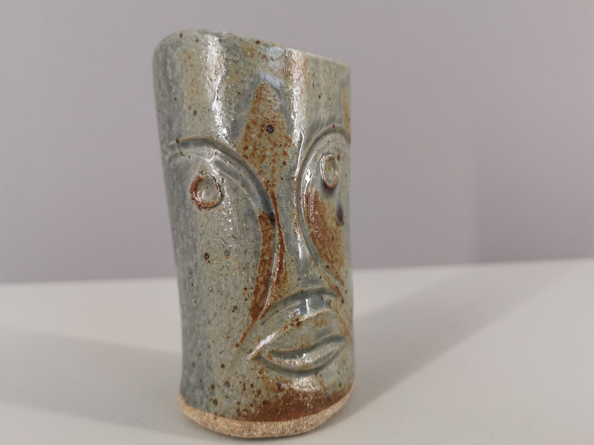 Signed vase in enamelled sandstone with stylized face