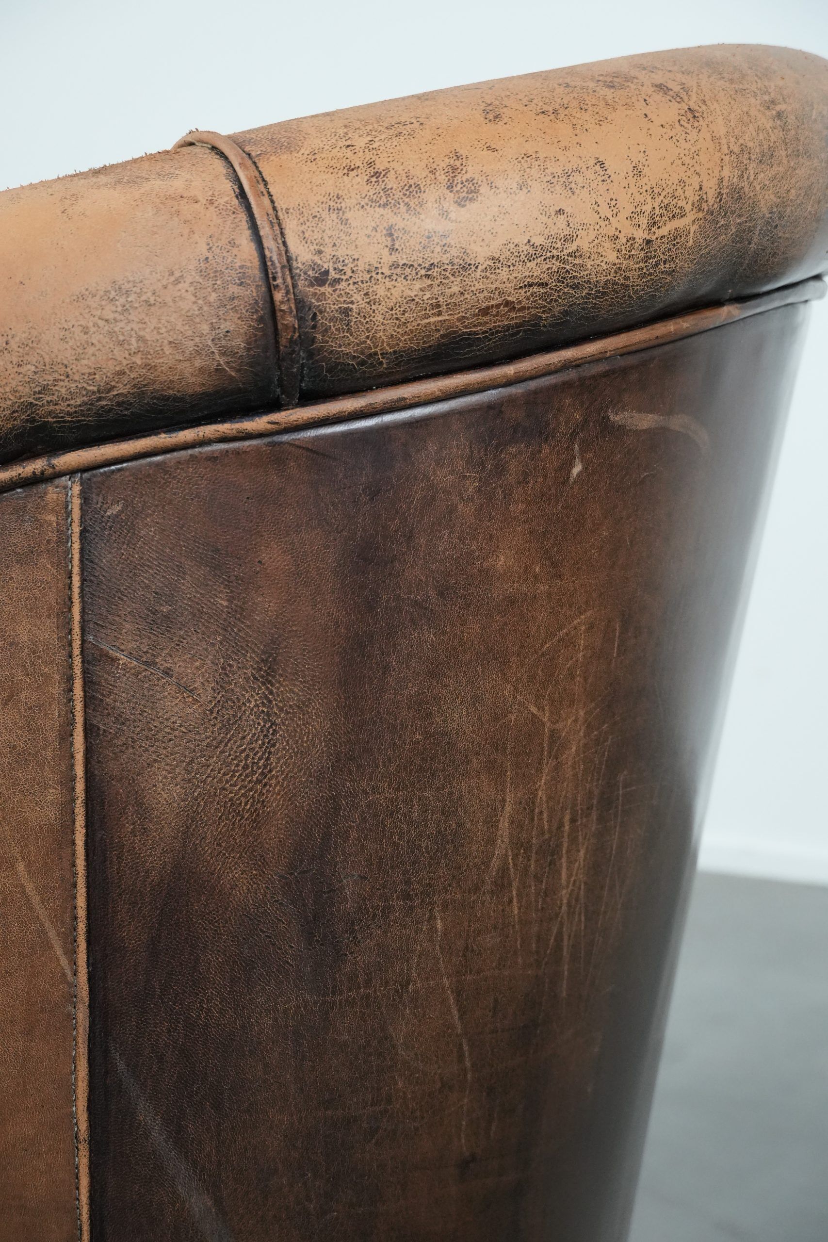 Vintage sheepskin club armchair with character and a beautiful patina