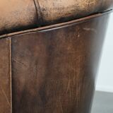 Vintage sheepskin club armchair with character and a beautiful patina