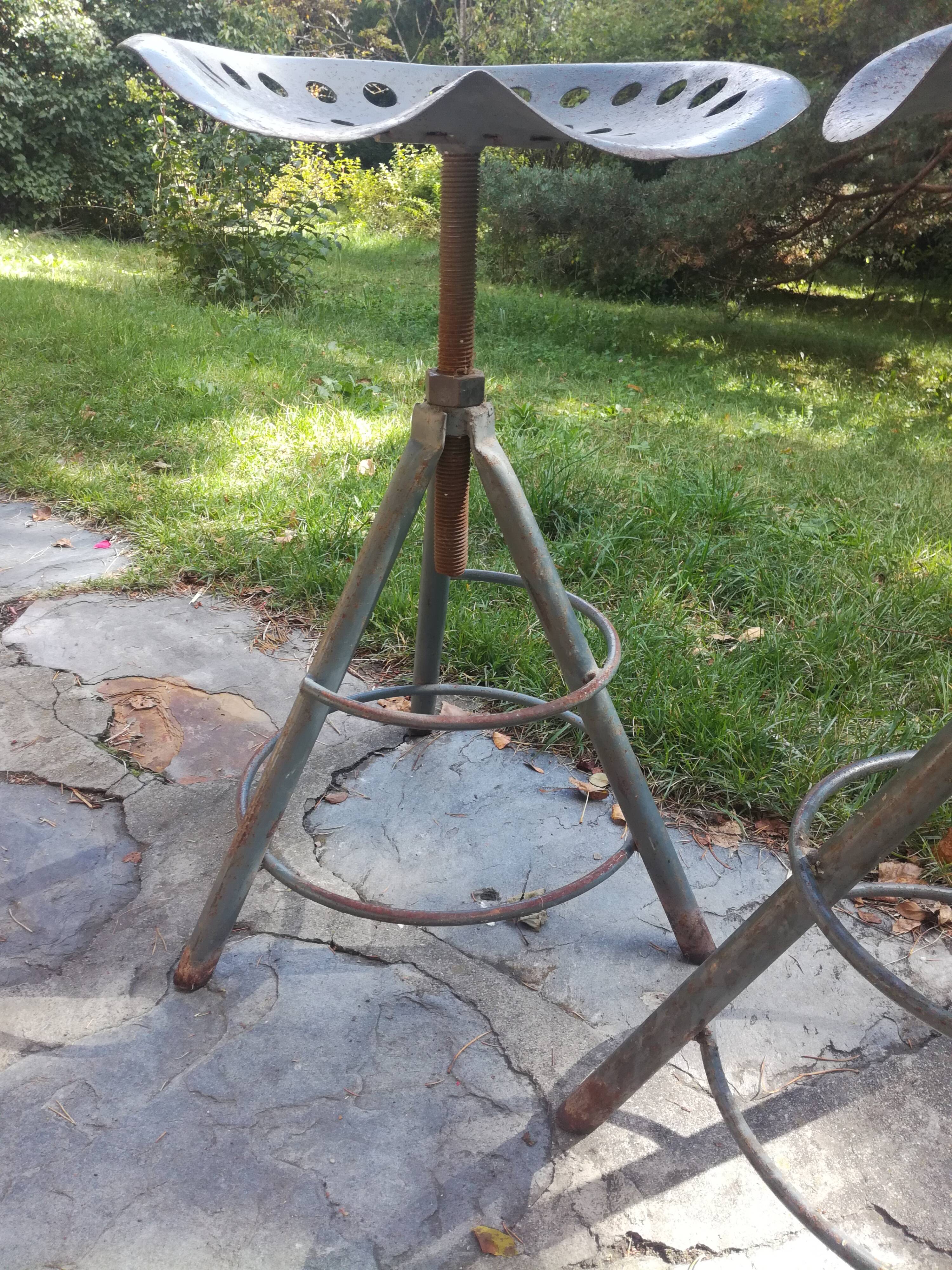Two tractor-style industrial stools