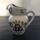 White pitcher with floral decoration
