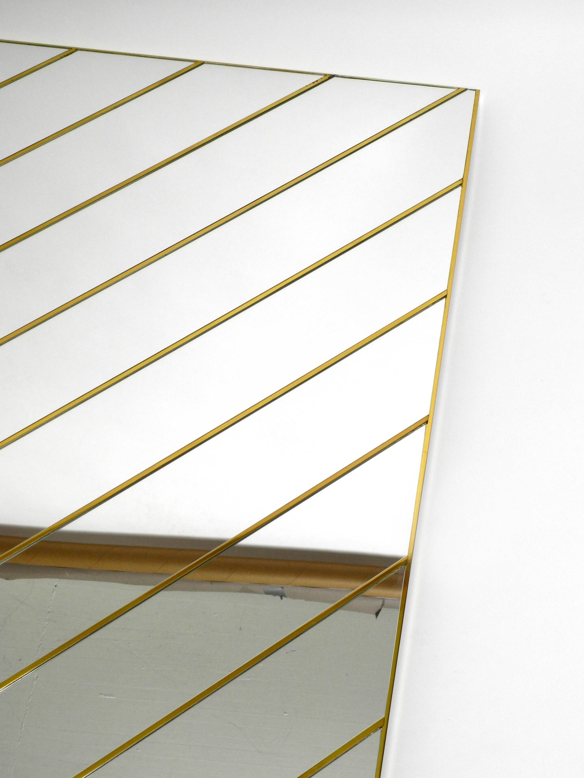 Large, exceptional 1970s brass wall mirror with diagonal mirror strips